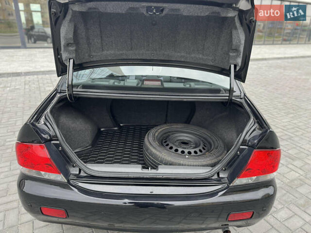 Чорний Міцубісі Lancer, об'ємом двигуна 1.58 л та пробігом 128 тис. км за 5999 $, фото 26 на Automoto.ua