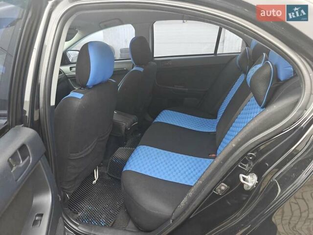 Черный Мицубиси Лансер, объемом двигателя 2 л и пробегом 228 тыс. км за 7000 $, фото 4 на Automoto.ua