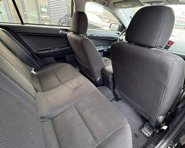 Черный Мицубиси Лансер, объемом двигателя 2 л и пробегом 156 тыс. км за 8999 $, фото 13 на Automoto.ua