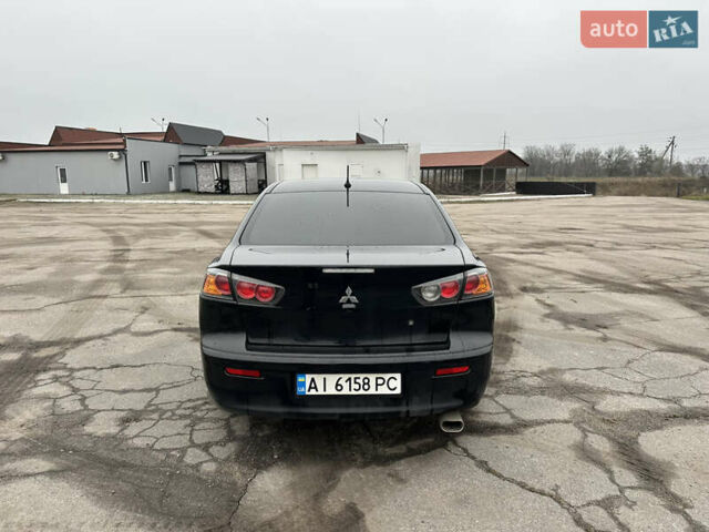 Черный Мицубиси Лансер, объемом двигателя 2 л и пробегом 142 тыс. км за 9500 $, фото 3 на Automoto.ua