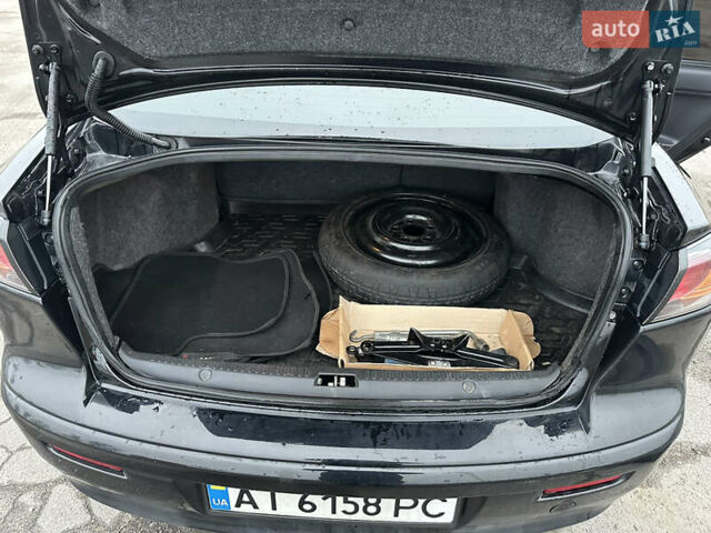 Черный Мицубиси Лансер, объемом двигателя 2 л и пробегом 142 тыс. км за 9500 $, фото 35 на Automoto.ua