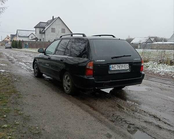 Чорний Міцубісі Lancer, об'ємом двигуна 2 л та пробігом 166 тис. км за 1699 $, фото 1 на Automoto.ua