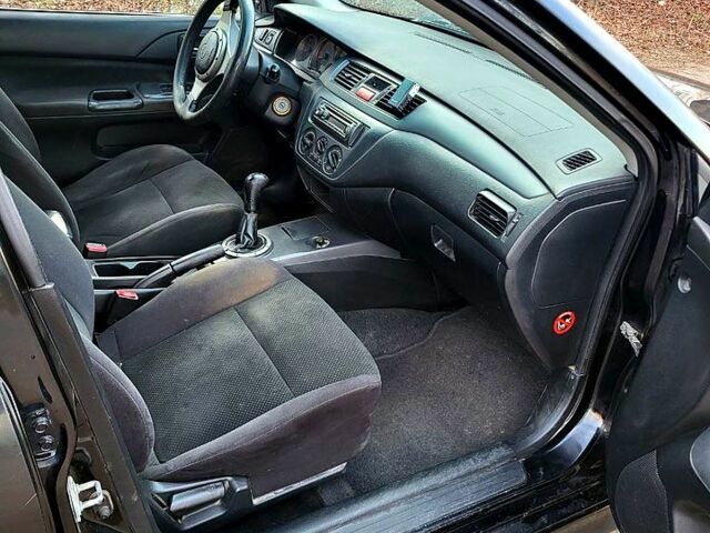 Чорний Міцубісі Lancer, об'ємом двигуна 1.6 л та пробігом 290 тис. км за 1999 $, фото 9 на Automoto.ua