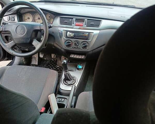 Черный Мицубиси Лансер, объемом двигателя 1.58 л и пробегом 336 тыс. км за 2600 $, фото 12 на Automoto.ua