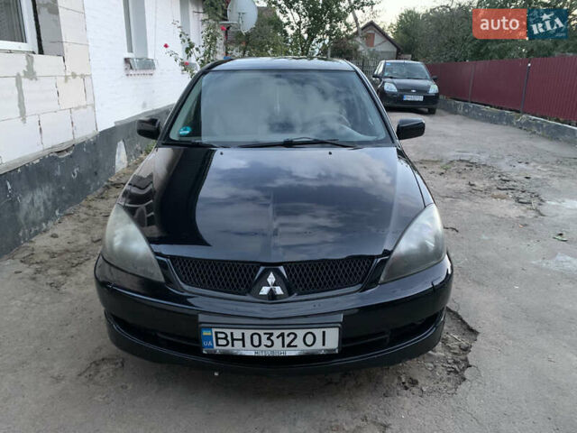 Черный Мицубиси Лансер, объемом двигателя 2 л и пробегом 212 тыс. км за 4500 $, фото 2 на Automoto.ua