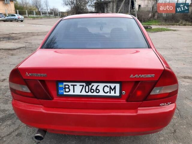 Красный Мицубиси Лансер, объемом двигателя 1.3 л и пробегом 409 тыс. км за 2000 $, фото 3 на Automoto.ua