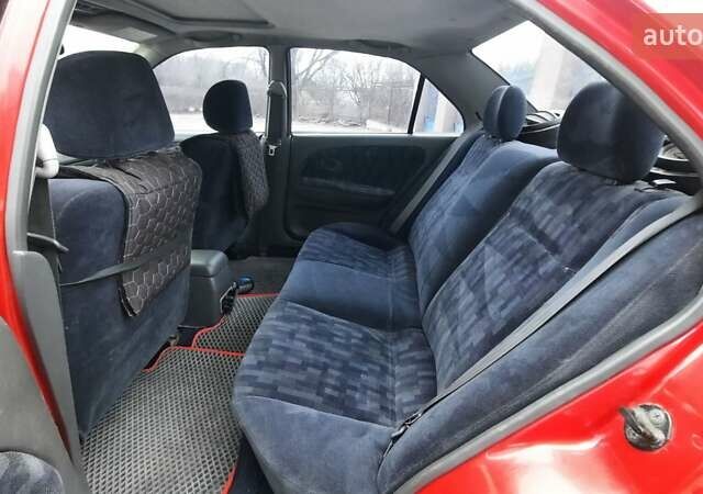 Красный Мицубиси Лансер, объемом двигателя 1.3 л и пробегом 409 тыс. км за 2000 $, фото 11 на Automoto.ua