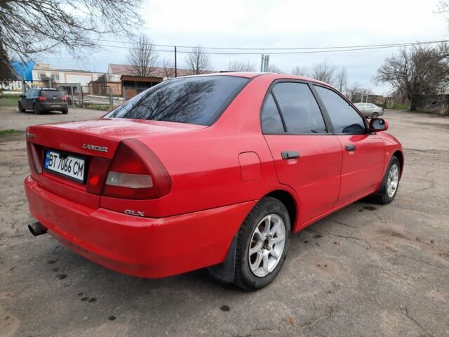 Красный Мицубиси Лансер, объемом двигателя 1.3 л и пробегом 409 тыс. км за 2000 $, фото 3 на Automoto.ua