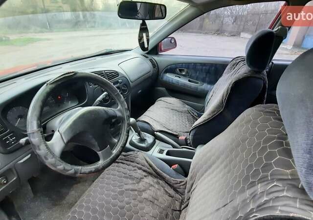 Красный Мицубиси Лансер, объемом двигателя 1.3 л и пробегом 409 тыс. км за 2000 $, фото 8 на Automoto.ua