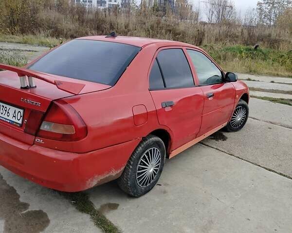 Червоний Міцубісі Lancer, об'ємом двигуна 1.3 л та пробігом 290 тис. км за 750 $, фото 4 на Automoto.ua