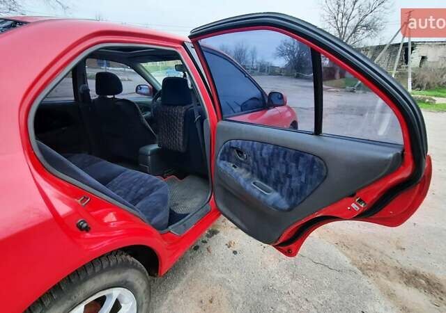 Красный Мицубиси Лансер, объемом двигателя 1.3 л и пробегом 409 тыс. км за 2000 $, фото 12 на Automoto.ua