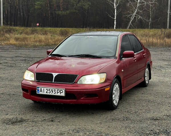 Красный Мицубиси Лансер, объемом двигателя 2 л и пробегом 202 тыс. км за 2599 $, фото 1 на Automoto.ua