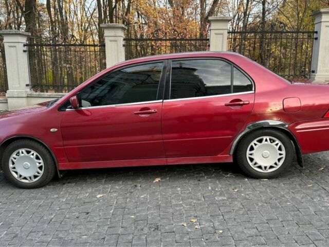 Красный Мицубиси Лансер, объемом двигателя 2 л и пробегом 350 тыс. км за 3399 $, фото 3 на Automoto.ua