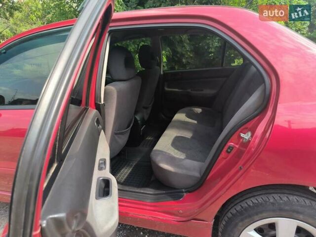 Красный Мицубиси Лансер, объемом двигателя 1.6 л и пробегом 400 тыс. км за 3100 $, фото 1 на Automoto.ua