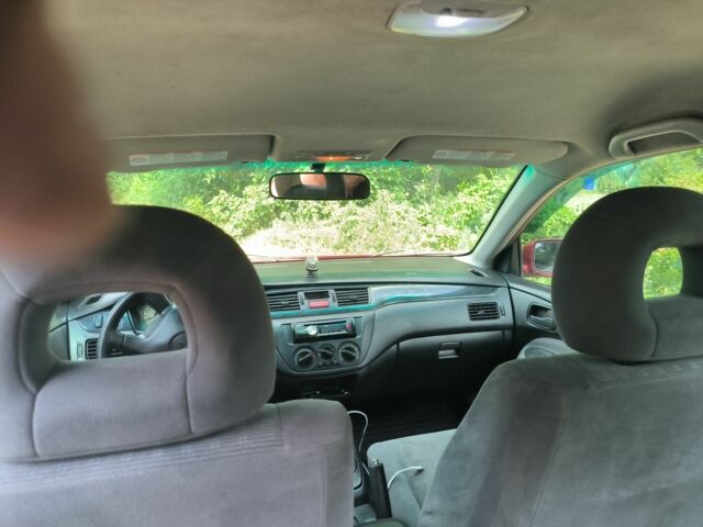 Красный Мицубиси Лансер, объемом двигателя 1 л и пробегом 2 тыс. км за 3100 $, фото 1 на Automoto.ua