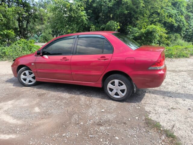 Красный Мицубиси Лансер, объемом двигателя 1 л и пробегом 2 тыс. км за 3100 $, фото 3 на Automoto.ua