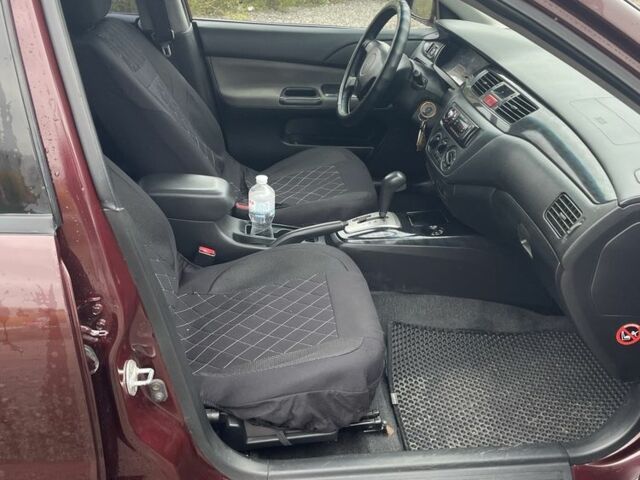 Красный Мицубиси Лансер, объемом двигателя 2 л и пробегом 295 тыс. км за 4150 $, фото 10 на Automoto.ua