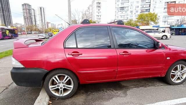 Красный Мицубиси Лансер, объемом двигателя 2 л и пробегом 320 тыс. км за 4600 $, фото 3 на Automoto.ua