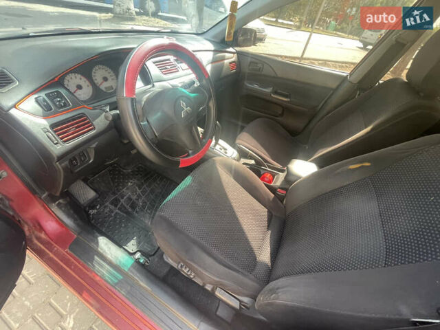 Червоний Міцубісі Lancer, об'ємом двигуна 1.58 л та пробігом 290 тис. км за 4250 $, фото 11 на Automoto.ua
