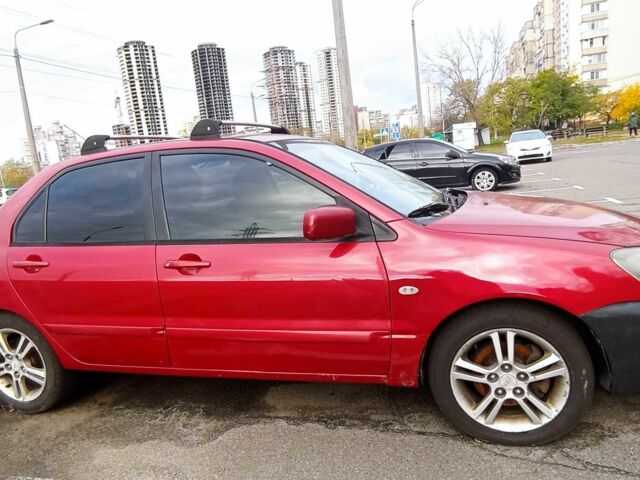 Красный Мицубиси Лансер, объемом двигателя 2 л и пробегом 320 тыс. км за 4600 $, фото 1 на Automoto.ua