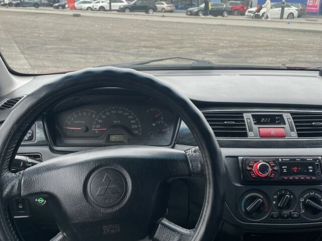 Красный Мицубиси Лансер, объемом двигателя 2 л и пробегом 295 тыс. км за 4150 $, фото 9 на Automoto.ua