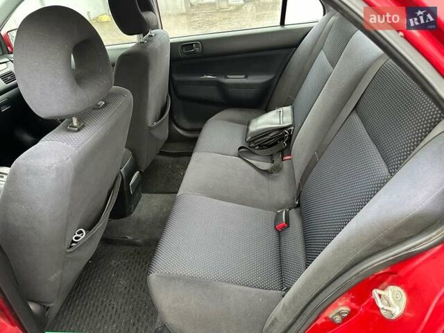 Красный Мицубиси Лансер, объемом двигателя 1.6 л и пробегом 185 тыс. км за 5000 $, фото 11 на Automoto.ua