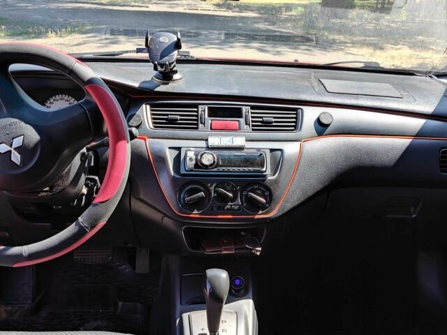 Красный Мицубиси Лансер, объемом двигателя 1.6 л и пробегом 216 тыс. км за 4500 $, фото 1 на Automoto.ua