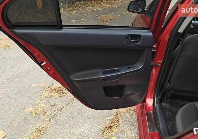 Красный Мицубиси Лансер, объемом двигателя 2 л и пробегом 186 тыс. км за 5600 $, фото 28 на Automoto.ua