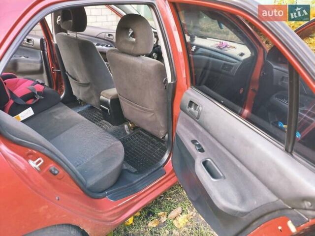 Красный Мицубиси Лансер, объемом двигателя 1.6 л и пробегом 214 тыс. км за 5000 $, фото 5 на Automoto.ua