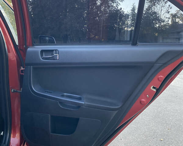 Червоний Міцубісі Lancer, об'ємом двигуна 2 л та пробігом 153 тис. км за 6700 $, фото 19 на Automoto.ua