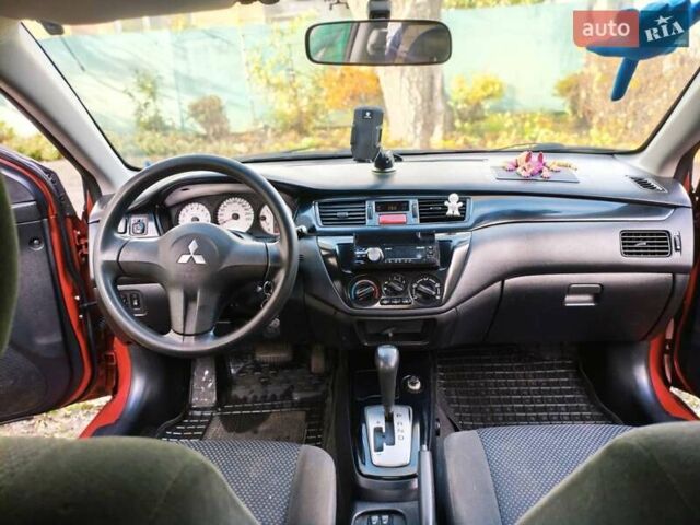 Красный Мицубиси Лансер, объемом двигателя 1.6 л и пробегом 214 тыс. км за 5000 $, фото 1 на Automoto.ua