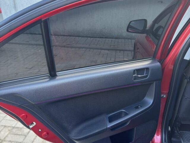 Красный Мицубиси Лансер, объемом двигателя 2 л и пробегом 267 тыс. км за 7000 $, фото 18 на Automoto.ua