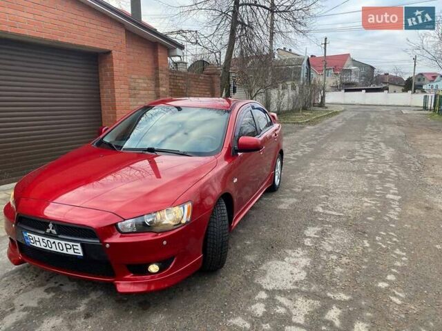 Красный Мицубиси Лансер, объемом двигателя 2 л и пробегом 66 тыс. км за 10000 $, фото 1 на Automoto.ua
