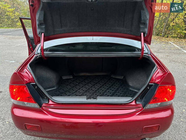 Красный Мицубиси Лансер, объемом двигателя 1.6 л и пробегом 192 тыс. км за 5999 $, фото 3 на Automoto.ua