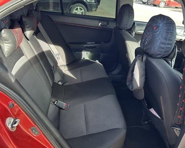 Красный Мицубиси Лансер, объемом двигателя 2 л и пробегом 227 тыс. км за 7000 $, фото 12 на Automoto.ua