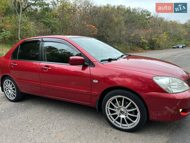 Красный Мицубиси Лансер, объемом двигателя 1.6 л и пробегом 192 тыс. км за 5999 $, фото 7 на Automoto.ua