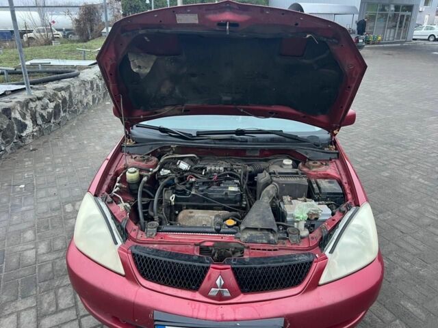 Красный Мицубиси Лансер, объемом двигателя 1.6 л и пробегом 265 тыс. км за 2956 $, фото 7 на Automoto.ua