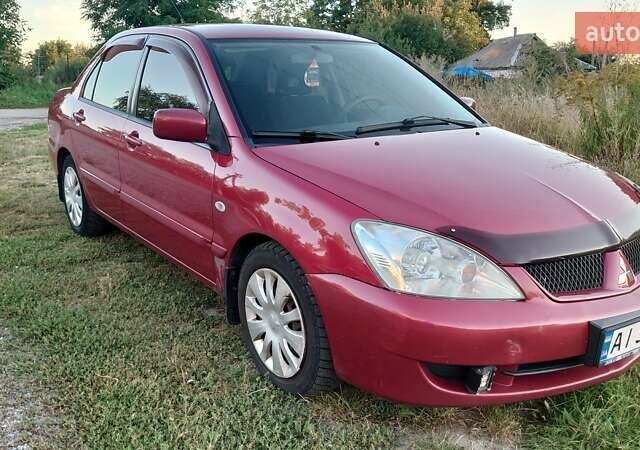 Красный Мицубиси Лансер, объемом двигателя 1.58 л и пробегом 198 тыс. км за 4650 $, фото 1 на Automoto.ua