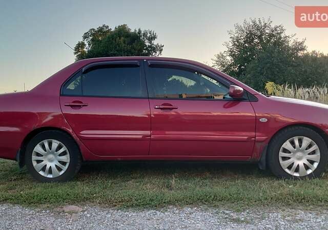 Красный Мицубиси Лансер, объемом двигателя 1.58 л и пробегом 198 тыс. км за 4650 $, фото 3 на Automoto.ua