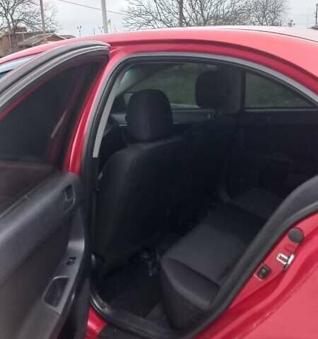Красный Мицубиси Лансер, объемом двигателя 2 л и пробегом 200 тыс. км за 6000 $, фото 6 на Automoto.ua