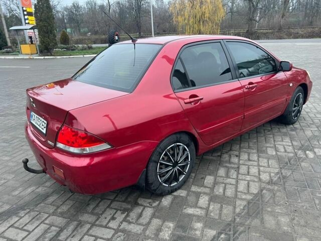 Красный Мицубиси Лансер, объемом двигателя 1.6 л и пробегом 265 тыс. км за 2956 $, фото 1 на Automoto.ua