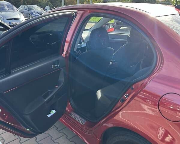 Красный Мицубиси Лансер, объемом двигателя 2 л и пробегом 227 тыс. км за 7000 $, фото 11 на Automoto.ua