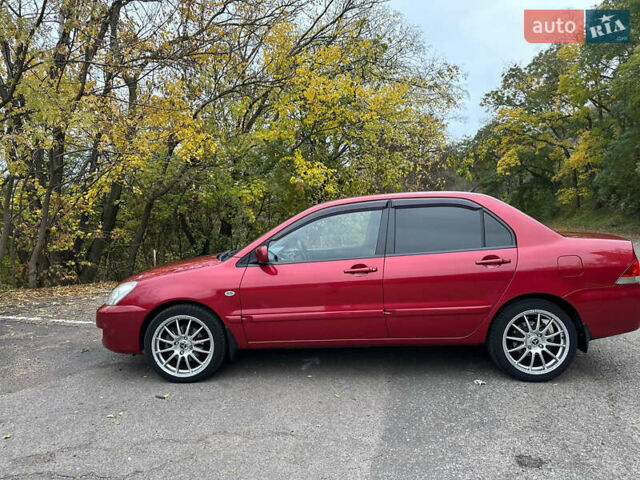 Красный Мицубиси Лансер, объемом двигателя 1.6 л и пробегом 192 тыс. км за 5999 $, фото 1 на Automoto.ua