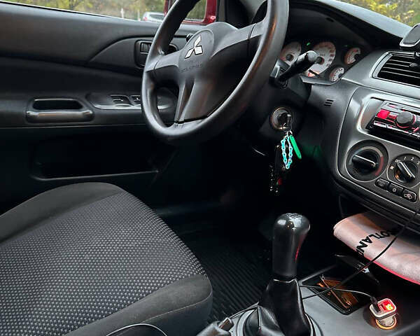 Красный Мицубиси Лансер, объемом двигателя 1.6 л и пробегом 192 тыс. км за 5999 $, фото 10 на Automoto.ua