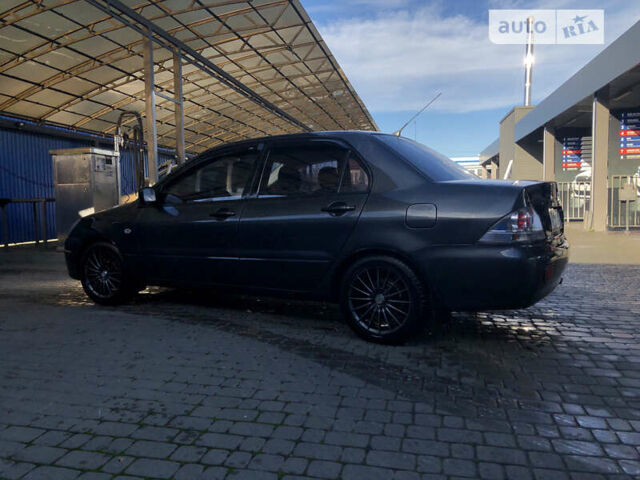Сірий Міцубісі Lancer, об'ємом двигуна 1.58 л та пробігом 232 тис. км за 2899 $, фото 18 на Automoto.ua