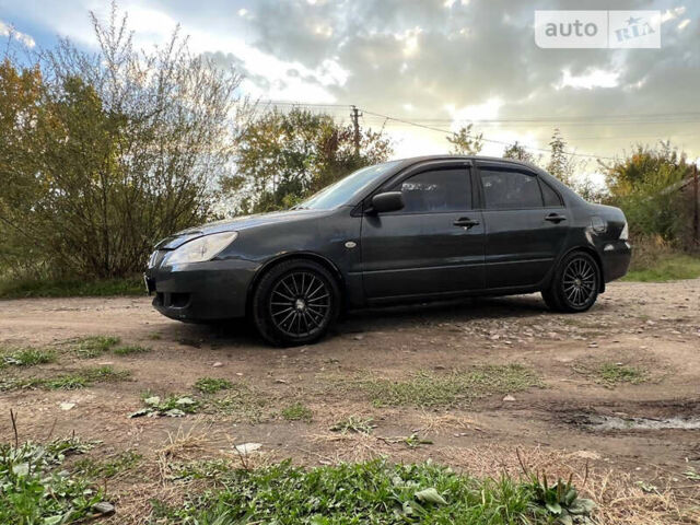 Сірий Міцубісі Lancer, об'ємом двигуна 1.58 л та пробігом 232 тис. км за 2899 $, фото 20 на Automoto.ua