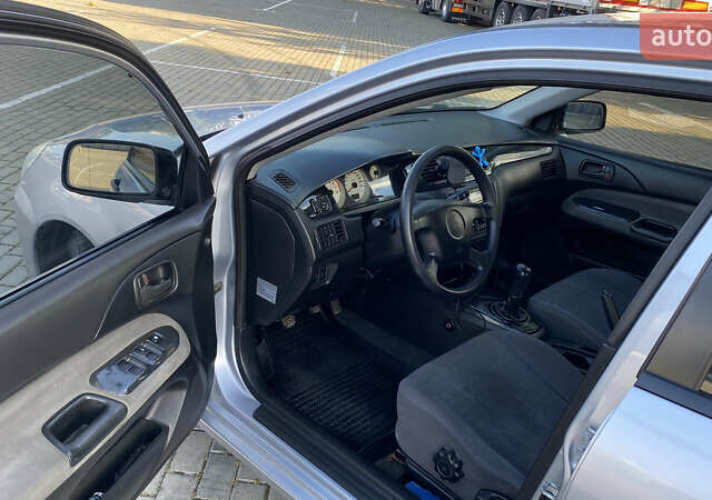 Сірий Міцубісі Lancer, об'ємом двигуна 1.58 л та пробігом 270 тис. км за 1999 $, фото 11 на Automoto.ua