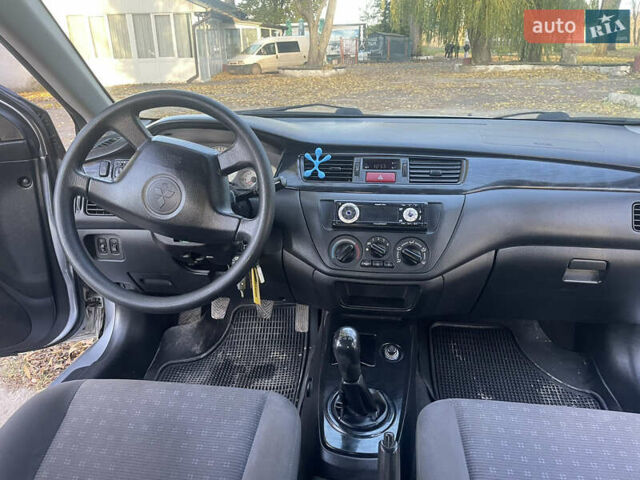 Сірий Міцубісі Lancer, об'ємом двигуна 1.58 л та пробігом 271 тис. км за 3000 $, фото 24 на Automoto.ua