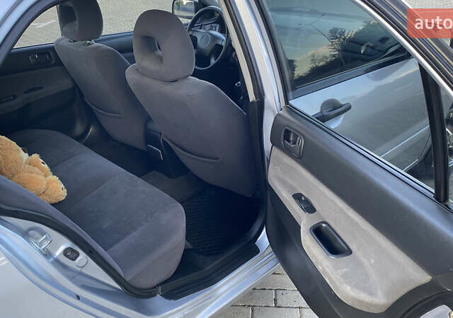 Сірий Міцубісі Lancer, об'ємом двигуна 1.58 л та пробігом 270 тис. км за 1999 $, фото 14 на Automoto.ua