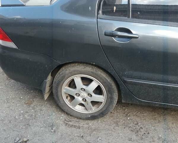 Сірий Міцубісі Lancer, об'ємом двигуна 1.58 л та пробігом 531 тис. км за 2828 $, фото 5 на Automoto.ua
